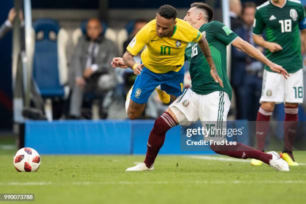 Neymar Jr of Brazil holds off Andres Guardado of Mexico during the 2018 FIFA World Cup Russia Round of 16 match between Brazil and Mexico at Samara...