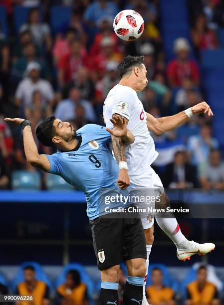 Jose Fonte of Portugal and Luis Suarez of Uruguay jump up to head the ball during the 2018 FIFA World Cup Russia Round of 16 match between Uruguay...