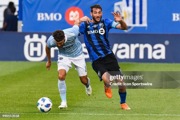 Sporting Kansas City defender Graham Zusi holds Montreal Impact midfielder Ignacio Piatti back to maintain control of the ball during the Sporting...