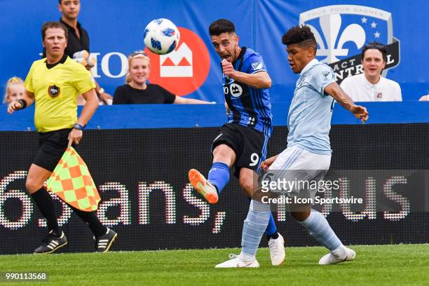 Montreal Impact midfielder Alejandro Silva kicks the ball before Sporting Kansas City defender Jaylin Lindsey blocks him during the Sporting Kansas...