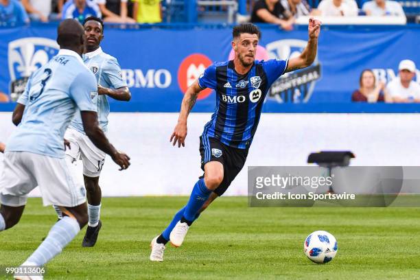 Montreal Impact midfielder Alejandro Silva escapes Sporting Kansas City defenders with the ball during the Sporting Kansas City versus the Montreal...