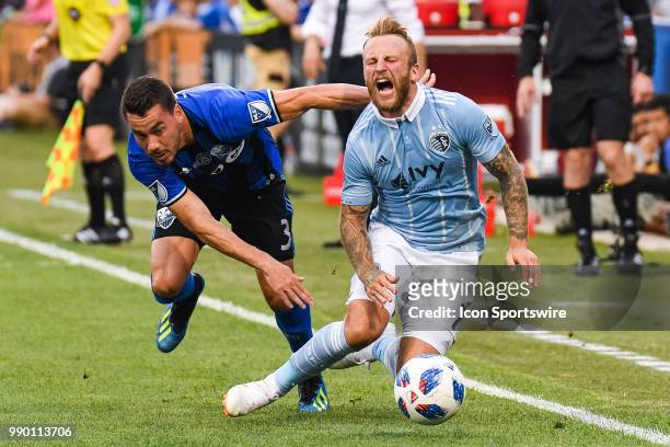Sporting Kansas City forward Johnny Russell falls on the ground after a collision with Montreal Impact defender Daniel Lovitz during the Sporting...