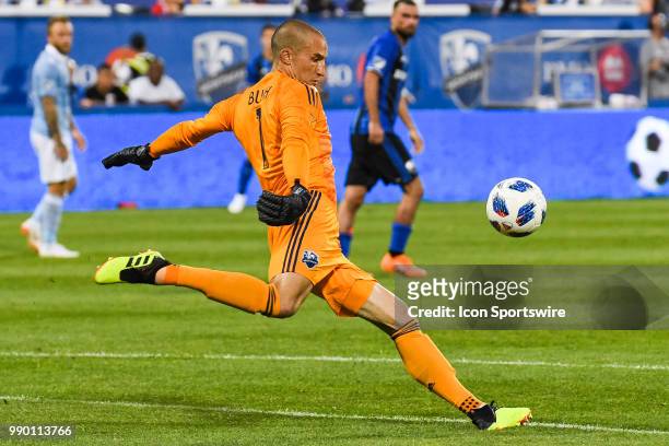 Montreal Impact goalkeeper Evan Bush kicks the ball back into play during the Sporting Kansas City versus the Montreal Impact game on June 30 at...