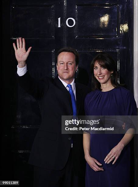 Prime Minister David Cameron waves from the steps of Number 10 Downing Street with his wife Samantha on May 11, 2010 in London, England. After five...