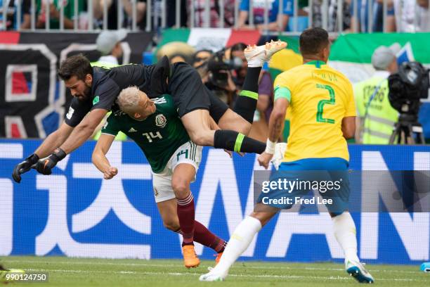 Javier Hernandez of Mexico fights for the ball with Alisson of Brazil during the 2018 FIFA World Cup Russia Round of 16 match between Brazil and...