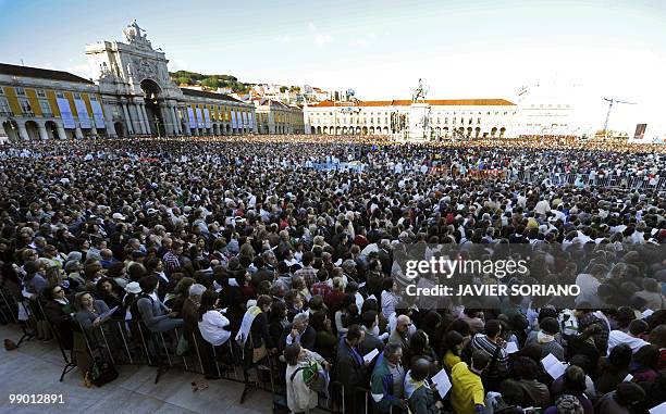 People stand during the Pope Benedict XVI's open-air mass in the Terreiro do Paco in Lisbon, on May 11, 2010. Tens of thousands of families,...