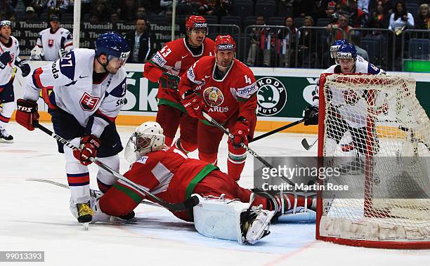 Ivan Ciernik of Slovakia scores over Vitali Koval, goalkeeper of Belarus his team's 2nd goal during the IIHF World Championship group A match between...