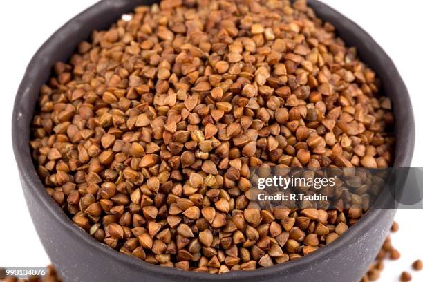 buckwheat groats in a bowl, close up photo - buckwheat isolated stock pictures, royalty-free photos & images