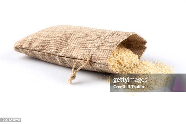 macro view of sesame seeds in flax sack with tie isolated on white background - 食品添加物 ストックフォトと画像