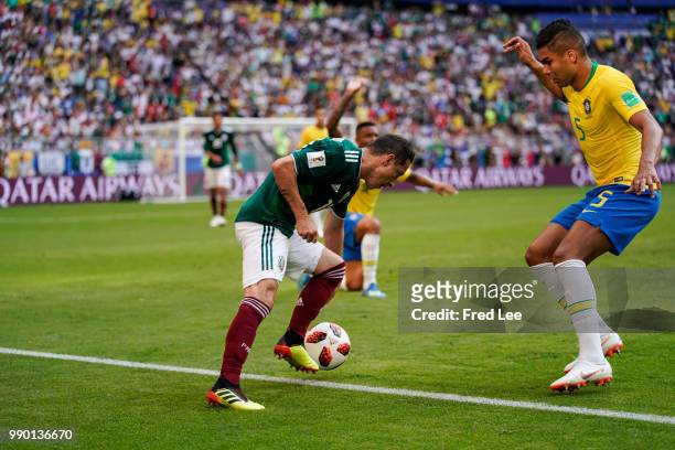 Casemiro of Brazil battles for possession with Hirving Lozano of Mexico during the 2018 FIFA World Cup Russia Round of 16 match between Brazil and...