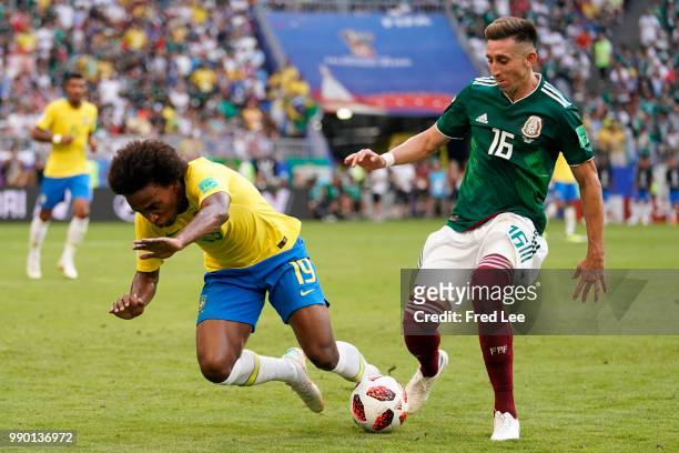 Willian of Brazil is challenged by Hector Herrera of Mexico during the 2018 FIFA World Cup Russia Round of 16 match between Brazil and Mexico at...