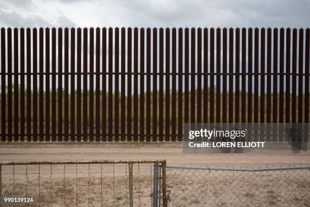This photo shows a section of the US-Mexico border fence behind the home of Eloisa Tamez, an activist and opponent of the fence, on June 18, 2018...