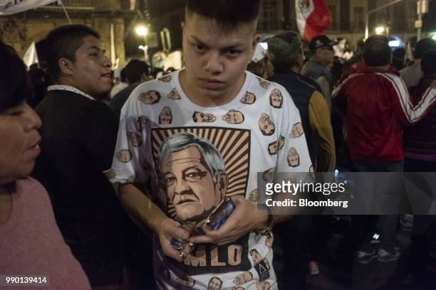 Supporter wears a campaign t-shirts during an election night rally for Andres Manuel Lopez Obrador, Mexico's president-elect, at Zocalo square in...