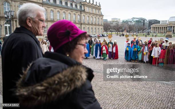 Baden-Wuerttemberg's Premier Winfried Kretschmann and his wife Gerlinde welcome carolers arrival for the traditional annual reception at the 'Neue...