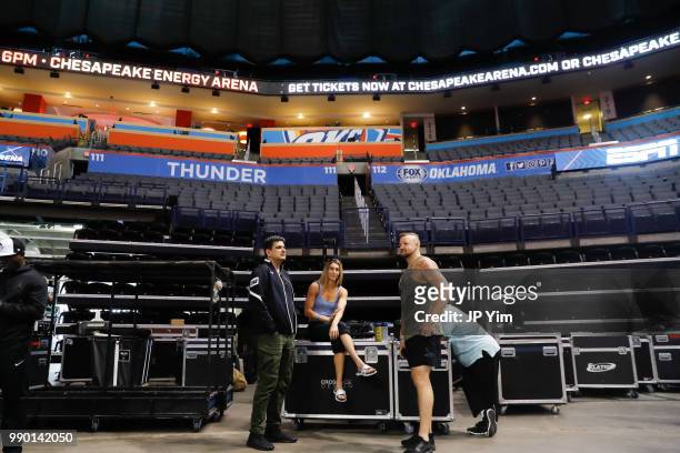 Boxer Mikaela Mayer talks with manager George Ruiz and fighter Trey Lippe Morrison before the start of the weigh in at the Chesapeake Energy Arena on...