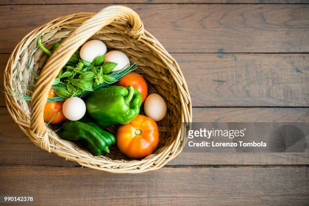 fresh, organic, healthy vegetable harvest variety in basket with eggs - eggs in basket stock pictures, royalty-free photos & images