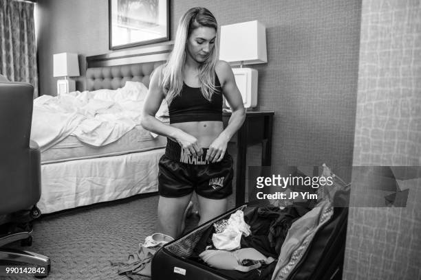 Boxer Mikaela Mayer gets ready in her hotel before heading out to the fight week press conference at Chesapeake Energy Arena on June 28, 2018 in...