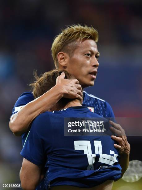 Keisuke Honda of Japan hugs his teammate Takashi Inui after the 2018 FIFA World Cup Russia Round of 16 match between Belgium and Japan at Rostov...