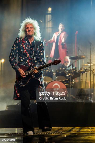 Brian May of Queen and Adam Lambert perform live on stage at The O2 Arena on July 2, 2018 in London, England.