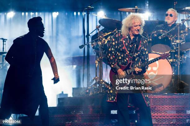 Adam Lambert , Brian May and Roger Taylor of Queen and Adam Lambert perform live on stage at The O2 Arena on July 2, 2018 in London, England.