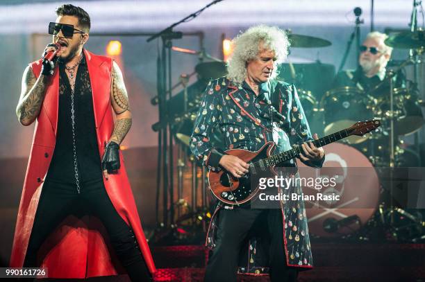 Adam Lambert , Brian May and Roger Taylor of Queen and Adam Lambert perform live on stage at The O2 Arena on July 2, 2018 in London, England.
