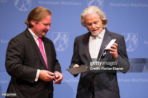 Hermann Buehlbecker receive his Order of Merit of North Rhine-Westphalia from Lutz Lienenkaemper on July 2, 2018 in Duesseldorf, Germany. Minister of...