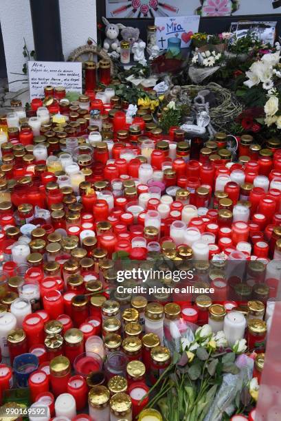 Flowers and candles lying on the floor in front of a pharmacy in remembrance of a 15-year old girl, who was stabbed by her boyfriend on 27 December...