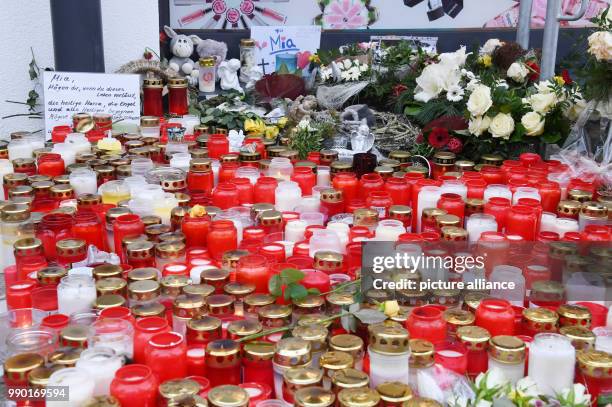 Flowers and candles lying on the floor in front of a pharmacy in remembrance of a 15-year old girl, who was stabbed by her boyfriend on 27 December...