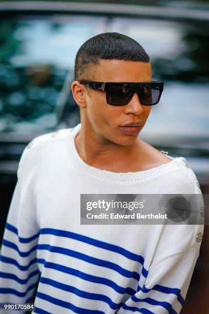 Olivier Rousteing wears a white pullover with blue stripes, outside Giambattista Valli, during Paris Fashion Week Haute Couture Fall Winter...