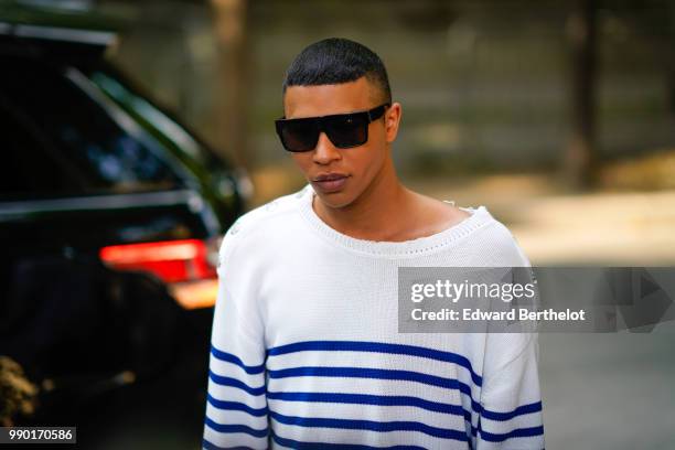 Olivier Rousteing wears a white pullover with blue stripes, outside Giambattista Valli, during Paris Fashion Week Haute Couture Fall Winter...