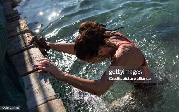 Orthodox believers try to retrieve a wooden crucifix during the annual Epiphany Day and the blessing of the waters celebrations in Piraeus near...