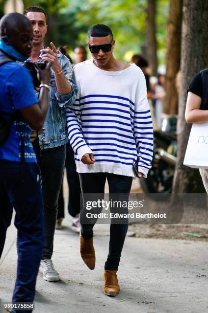 Olivier Rousteing wears a white pull over with blue stripes, outside Giambattista Valli, during Paris Fashion Week Haute Couture Fall Winter...