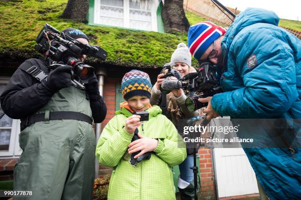William Etherton from England takes a look at the stranded camera in Hallig Suederoog, Germany, 6 January 2018. The action camera floated for months...