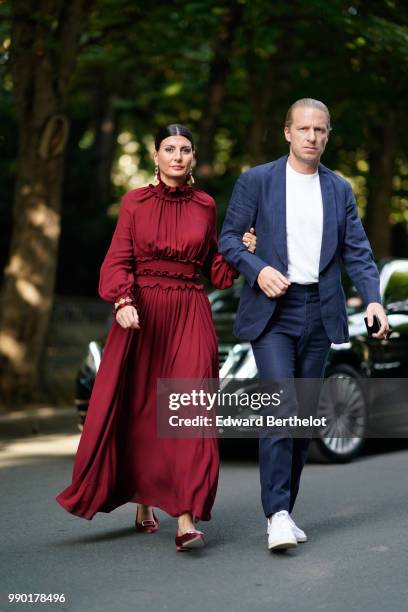 Giovanna Battaglia wears a red dress, outside Giambattista Valli, during Paris Fashion Week Haute Couture Fall Winter 2018/2019, on July 2, 2018 in...