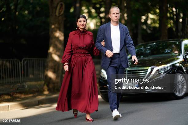 Giovanna Battaglia wears a red dress, outside Giambattista Valli, during Paris Fashion Week Haute Couture Fall Winter 2018/2019, on July 2, 2018 in...