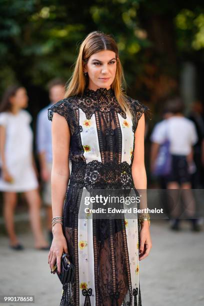 Bianca Brandolini wears a black lace mesh dress, outside Giambattista Valli, during Paris Fashion Week Haute Couture Fall Winter 2018/2019, on July...