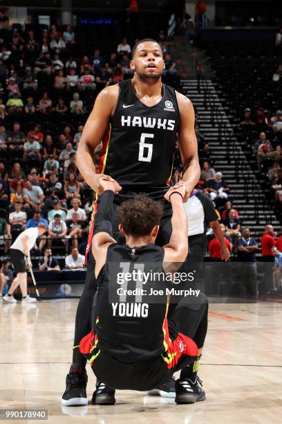 Omari Spellmand helps Trae Young of the Atlanta Hawks from the floor during the 2018 Summer League at the Vivint Smart Home Arena on July 2, 2018 in...