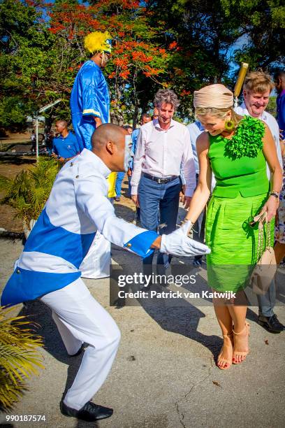 King Willem-Alexander of The Netherlands and Queen Maxima of The Netherlands visits Excel Arts Academy during the Dia di Bandera celebrations on July...