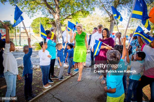 King Willem-Alexander of The Netherlands and Queen Maxima of The Netherlands visits Excel Arts Academy during the Dia di Bandera celebrations on July...