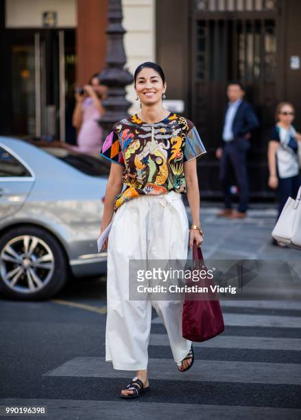 Caroline Issa wearing white wide leg pants, Prada bag is seen outside Schiaparelli on day two during Paris Fashion Week Haute Couture FW18 on July 2,...
