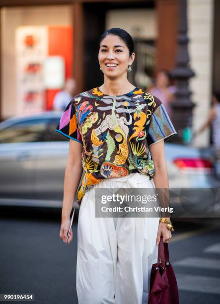 Caroline Issa wearing white wide leg pants, Prada bag is seen outside Schiaparelli on day two during Paris Fashion Week Haute Couture FW18 on July 2,...