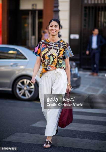 Caroline Issa wearing white wide leg pants, Prada bag is seen outside Schiaparelli on day two during Paris Fashion Week Haute Couture FW18 on July 2,...