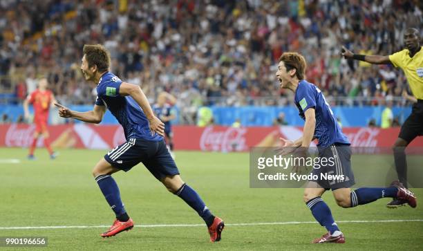 Genki Haraguchi of Japan and his teammate Yuya Osako celebrate after Haraguchi scored their team's first goal during the second half of a World Cup...