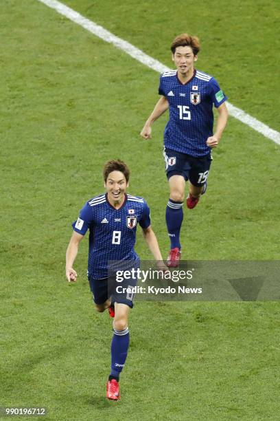 Genki Haraguchi of Japan celebrates along with his teammate Yuya Osako after Haraguchi scored a goal during the second half of a World Cup...