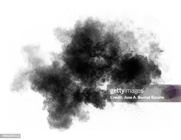 full frame of forms and textures of an explosion of powder and smoke of color gray and black on a white background. - black smoke stock-fotos und bilder