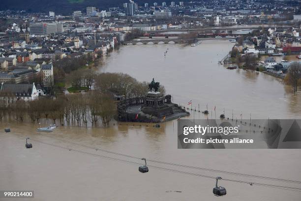 The "Deutsches Eck" headland with the equestrian statue of Kaiser Wilhelm are surrounded by flood waters in Koblenz, Germany, 07 January 2018. Photo:...