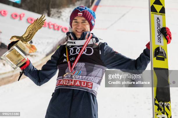 Kamil Stoch of Poland celebrates with the golden eagle trophy for the overall victory in the Four Hills Tournament in Bischofshofen, Austria, 6...