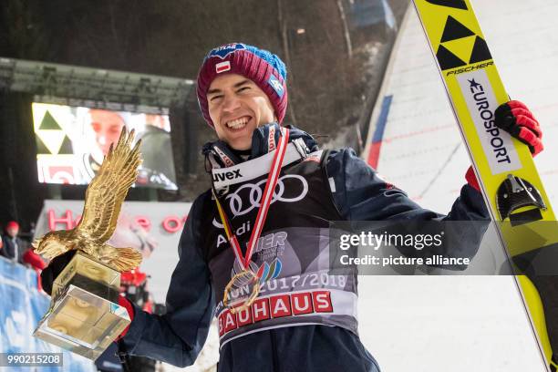 Poland's Kamil Stoch celebrates the victory at the Four Hills Tournament with his trophy in Bischofshofen, Austria, 06 January 2018. Stoch won in...