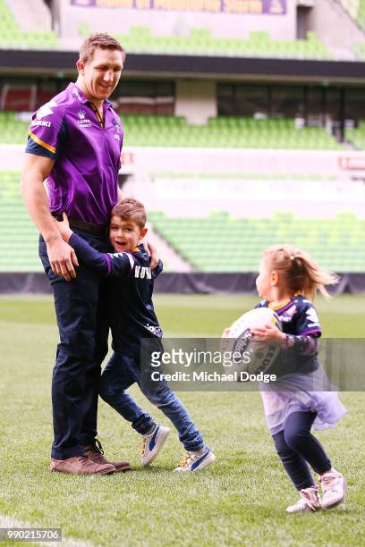 Melbourne Storm veteran Ryan Hoffman plays with his children Mia and Zach during a press conference to announcement his retirement on July 3, 2018 in...