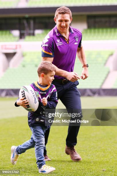 Melbourne Storm veteran Ryan Hoffman plays with his son Zach during a press conference to announcement his retirement on July 3, 2018 in Melbourne,...